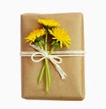 Package wrapped in paper and tied with a rope and flowers