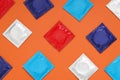 Packaged condoms on orange background, flat lay. Safe sex