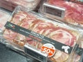 Packaged italian porchetta with discount label in store display Royalty Free Stock Photo