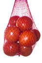 Packaged tomatoes hanging in red plastic net Royalty Free Stock Photo