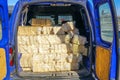 Packaged wood sawdust briquettes loaded in a car, biofuel with good heat output Royalty Free Stock Photo