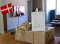 Packages with birthday gifts and the danish flag in the room of the apartment.