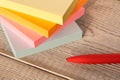 Packages of colorful stickers for notes and a pen on a wooden table Royalty Free Stock Photo