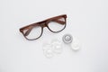 Packages with contact lenses, case and glasses on white background, flat lay Royalty Free Stock Photo