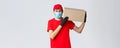 Packages and parcels delivery, covid-19 quarantine delivery, transfer orders. Friendly courier bring order to client Royalty Free Stock Photo