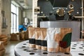 Packages with variety coffee on roasting machine