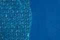 Packaging with air bubbles on a blue background. Bubble wrap texture, packaging, air bubble film. Top view. Copy, empty space for Royalty Free Stock Photo