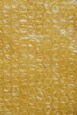 Packaging with air bubbles on a yellow background. Bubble wrap texture, packaging, air bubble film. Top view. Copy, empty space Royalty Free Stock Photo