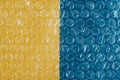 Packaging with air bubbles on a yellow and blue background. Bubble wrap texture, packaging, air bubble film. Copy, empty space for Royalty Free Stock Photo