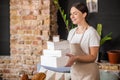 Pretty neat woman carrying baking packing boxes