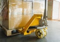 Packaging Boxes on Pallet with Hand Pallet Jack. Supply Chain. Shipping Cargo Import - Export. Royalty Free Stock Photo