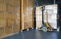 Packaging Boxes on Pallets Racks with Hand Pallet Truck in Storage Warehouse. Supply Chain. Storehouse Shipment Goods Distribution Royalty Free Stock Photo