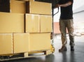 Packaging Boxes Stacked on Pallets. Cartons Goods Boxes. Workers Unloading Cartons of Products in the Warehouse. Supply Chain Royalty Free Stock Photo