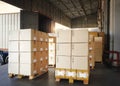 Packaging Boxes Stacked on Pallets Loading into Cargo Container. Cardboard Boxes. Shipping Trucks. Supply Chain Shipment. Logistic Royalty Free Stock Photo