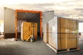 Packaging Boxes Stacked on Pallets Loading into Cargo Container. Delivery Shipping Trucks. Supply Chain Shipment Goods. Royalty Free Stock Photo