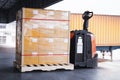 Packaging Boxes Wrapped Plastic Film on Pallet with Electric Forklift Pallet Jack in The Warehouse. Cargo Shipment Boxes. Delivery Royalty Free Stock Photo