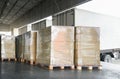 Packaging Boxes Wrapped Plastic Stacked on Pallets Loading into Cargo Container. Delivery Shipping Trucks. Supply Chain Shipment. Royalty Free Stock Photo