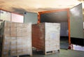 Packaging Boxes Wrapped Plastic Stacked on Pallets Loading into Cargo Container. Distribution Supplies Warehouse. Shipping Trucks.