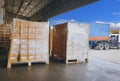 Packaging Boxes Wrapped Plastic Stacked on Pallets Loading into Cargo Container. Distribution Supplies Warehouse. Shipping Trucks. Royalty Free Stock Photo
