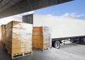 Packaging Boxes Wrapped Plastic Stacked on Pallets Loading into Cargo Container. Loading Dock Shipping Trucks. Supply Chain. Royalty Free Stock Photo