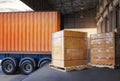 Packaging Boxes Wrapped Plastic Stacked on Pallets Loading into Cargo Container. Shipping Trucks. Supply Chain Shipment. Royalty Free Stock Photo