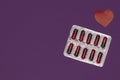 Packaging of capsules, tablets on a purple background to protect and protect the health of patients with epilepsy. Royalty Free Stock Photo