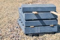 Packaging curb stone at the construction site. Pallet with concrete curbs for sidewalk construction Royalty Free Stock Photo