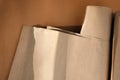 Packaging of eco-materials. Packaging paper on a brown background. Concept saving the planet from undetectable debris Royalty Free Stock Photo