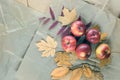 Packaging in kraft paper using autumn yellow leaves and apples. Autumn background. Top view, copy space
