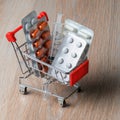 Packaging of medical tablets in the shopping cart. Purchase of medicinal tablets. Protection from virus infection