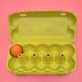 Packaging with one egg in a cardboard box on a pink background Royalty Free Stock Photo