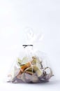 Vertical image of eco bag full of vegetables peelings in it on the white background.Concept of eco friendly packaging and recyclin