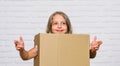 Packaging things. Prepare for moving. Rent house. Real estate. Make moving easier. Girl small child carry cardboard box