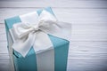 Packed blue gift box on wooden board celebrations concept Royalty Free Stock Photo