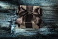 Packed brown gift box on wooden board