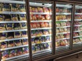 Packed chicken nugget in various brand placed in display chiller refrigerator inside the huge supermarket.