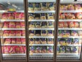 Packed chicken nugget in various brand placed in display chiller refrigerator inside the huge supermarket.