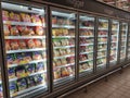 Packed chicken nugget in various brand placed in display chiller refrigerator inside the huge supermarket.