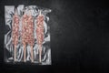 Packed kebab from lamb or mutton meat, on black dark stone table background, top view flat lay, with copy space for text Royalty Free Stock Photo