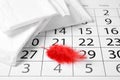 Packed menstrual pads with red feather and calendar