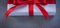 Packed present box on grey surface holidays concept Royalty Free Stock Photo