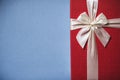 Packed red present with bow on blue background. Royalty Free Stock Photo