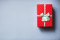 Packed red present with bow on blue background. Royalty Free Stock Photo
