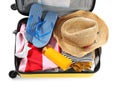 Packed suitcase with summer clothes and accessories