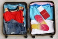 Packed suitcase with summer clothes