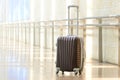 Packed travel suitcase, airport. Summer holiday and vacation concept. Traveler baggage, brown luggage in empty hall
