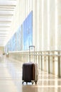 Packed travel suitcase, airport. Summer holiday and vacation concept. Traveler baggage, brown luggage in empty hall