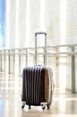 Packed travel suitcase, airport. Summer holiday and vacation concept. Traveler baggage, brown luggage in empty hall