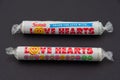 A packet of Love Heart candy sweets on a black background