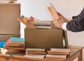 Packing books in a cardboard box Royalty Free Stock Photo